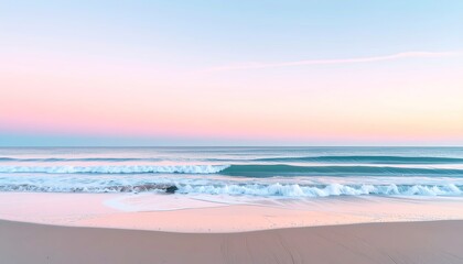Obraz premium Serene beach landscape at sunrise with gentle waves and pastel sky reflecting soft pink and blue hues on the wet sand.