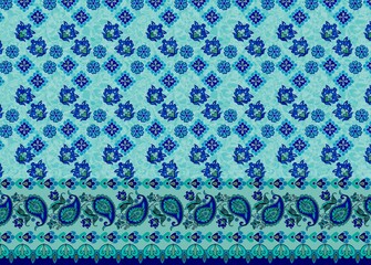 Blue and green paisley floral textile with ornamental border on a light background