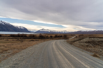 Driving up Lilybank road alongside Lake Tekapo towards the snowy Mount Cook mountain ranges