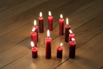 red candle on wooden floor. Ritual at home