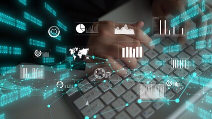 A business professional engages in data analysis using a keyboard, surrounded by dynamic graphs and charts, showcasing modern technology in an office environment. Xenic