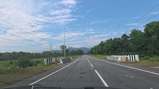 23.10.2025.Bagrakote West Bengal India  4k video clip of a road trip in a car as seen from driver point of view on a bright sunny day in India