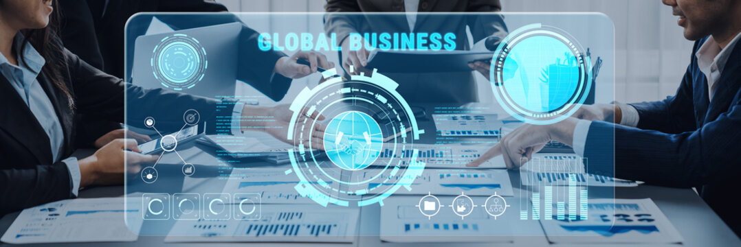 A business team collaborates on global strategies, utilizing digital analytics and data insights in a modern office setting to drive growth and innovation. Trope - Powered by Adobe