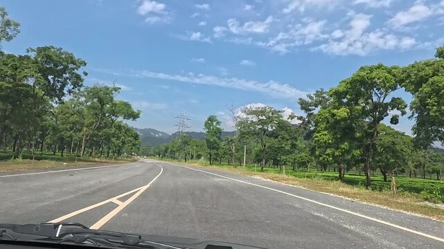 23.10.2025.Bagrakote West Bengal India  4k video clip of a road trip in a car as seen from driver point of view on a bright sunny day in India