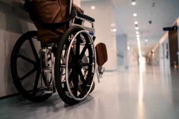 A hospital room with a wheelchair in the corner
