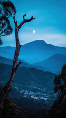 Scenic Mountain Landscape at Dusk with Half Moon, Tree Silhouette, and Distant Village Lights in a Serene Blue Hued Environment