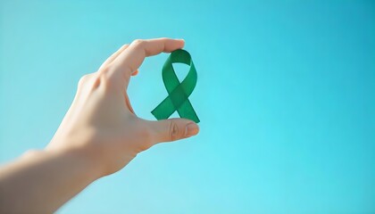 A hand with a green ribbon against a blue sky highlights Glaucoma Awareness, emphasizing the importance of eye examinations