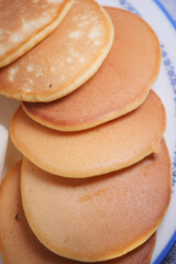 Fluffy pancakes stacked on a plate ready to serve