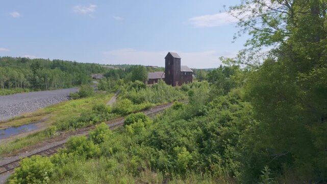 Headframe of old silver mine beside railway tracks in Cobalt Mining District Historic Site of Canada