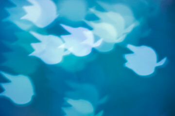 White lily of the valley bokeh on dark background – abstract small floral holiday background, front view