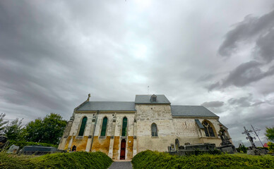 Bergnicourt, Rethel, Ardennes, Grand-Est, France, August, 28th, 2025,An ancient church stands resiliently against a dramatic backdrop of ominous and stormy clouds on the horizon
