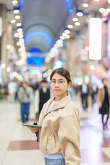 Woman tourist sightseeing Sendai shopping road. Happy traveler travel near Sendai station, Miyagi Prefecture, Japan. Famous Landmark and Vacation