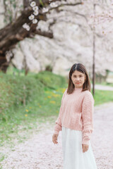 Woman tourist sightseeing Kajo Park Yamagata Castle Ruins with Sakura Cherry Blossom in Spring,...