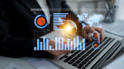 A businessman analyzes data on a laptop, featuring digital graphs and charts, representing modern...