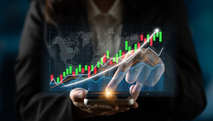 A business professional uses a smartphone to analyze stock market growth data displayed on a dynamic financial graph, representing upward trends and analytics. Impute