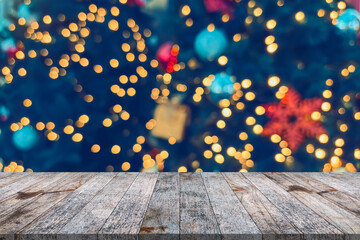Empty wood table top with blur Christmas tree with bokeh light background