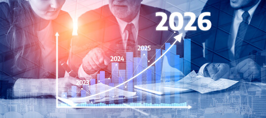 Business professionals engage in an analysis of growth projections, showcasing a digital chart that...