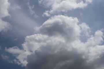 White fluffy clouds under bright daylight.