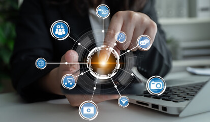 A business professional interacts with digital icons representing various aspects of communication and technology, showcasing modern workspace dynamics and multimedia interactions. Crux