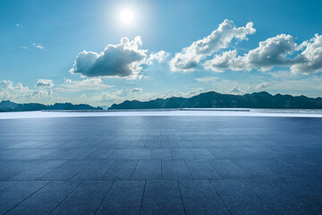 Empty square floor and mountain with beautiful sky clouds landscape under a sunny blue sky