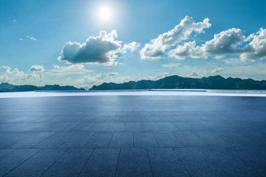 Empty square floor and mountain with beautiful sky clouds landscape under a sunny blue sky - Powered by Adobe