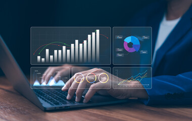 Analyzing digital business data, financial growth, and market strategy using futuristic charts and graphs displayed on a laptop screen. Concepts of technology and investment.