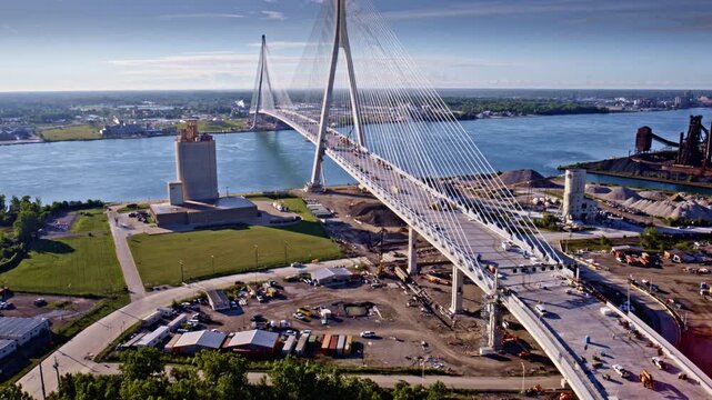 Cinematic aerial orbit capturing the bridge that spans the border of the U.S. and Canada.