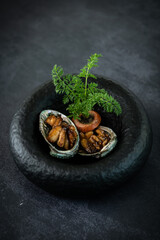 Gourmet Abalone Delicacy Served in a Black Pot