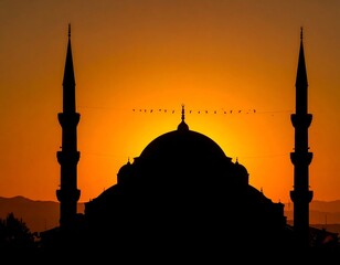 Silhouette of a religious building against a fiery sunset