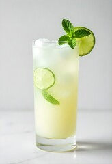 Exotic mango mojito cocktail in a tall glass decorated with mango slices lime and mint