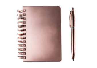 A rose gold notebook with spiral binding and a matching pen, set against a black backdrop