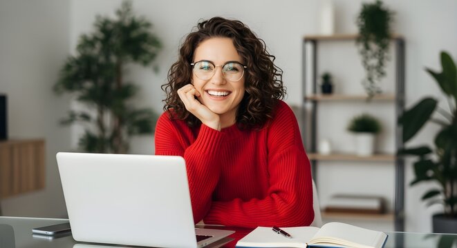 Happy Woman Working Remotely from Home Office with Laptop and Notebook.