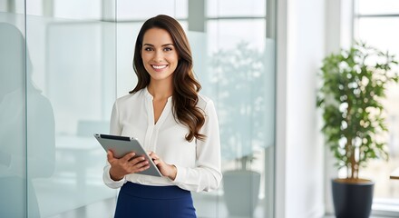 Smiling Businesswoman Holding Tablet in Modern Office.