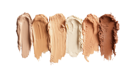 Swatches of foundation makeup shades, ranging from light to dark, smeared on a black surface