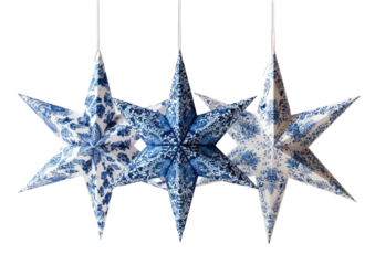 Three hanging, paper star ornaments with blue and white floral patterns against a black background
