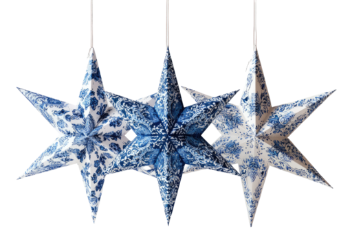 Three hanging, paper star ornaments with blue and white floral patterns against a black background