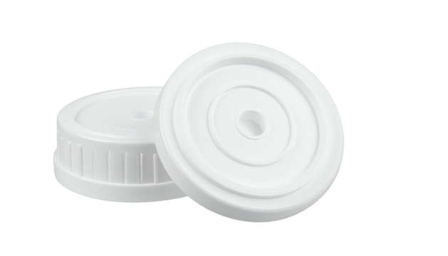 Two white plastic bottle caps with textured sides on dark base