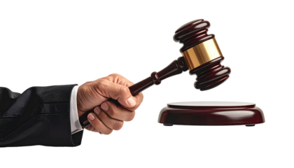 Gavel being held above striking block against black backdrop