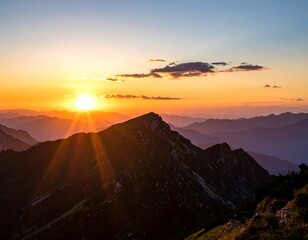 Mountain range silhouettes at sunset with orange, blue, and yellow hues