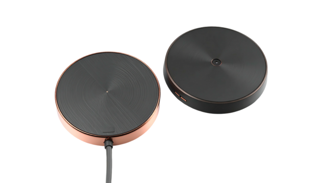 Two round metallic pads with cords on black background