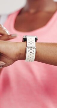 Woman, hands or smart watch in studio for exercise, tracking heart rate or fitness progress app. Person, scroll or check time for workout results, wellness or monitor step counter on white background