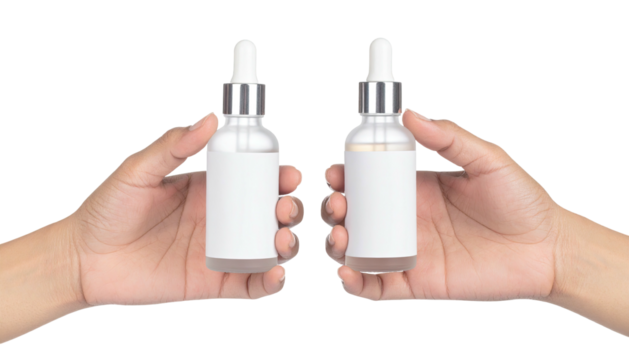 Hands hold two small bottles with droppers. Isolated