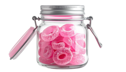 Glass jar filled with pink candy rings, lid ajar on the side