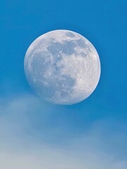 Close-up of the full moon's surface and texture during the day.
