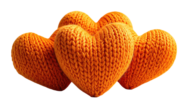Four orange, knitted hearts cluster against a black background