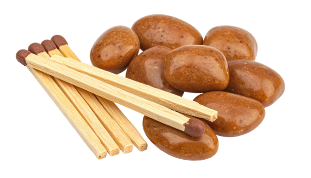 Matches lay beside pile of glazed, oval-shaped, light-brown rocks