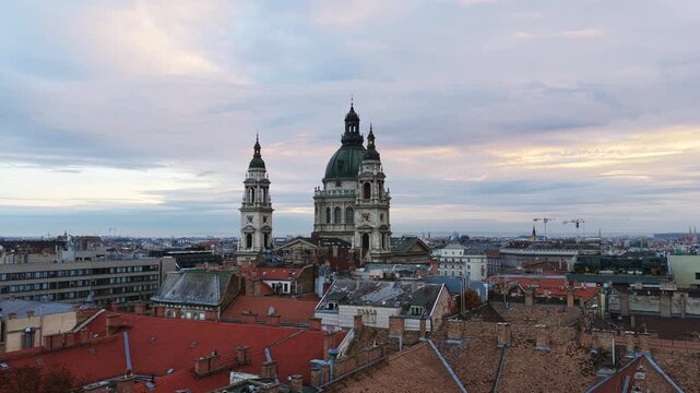 St. Stephen&rsquo;s Basilica rises over Budapest&rsquo;s rooftops at dusk, framed by soft clouds and historic charm.