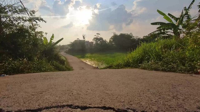 Footage of RC cars with a camera, riding on an empty street with rice paddies on the left and right. Experience the adventure of remote control cars on outdoor roads with low-angle shots in 4K Footage