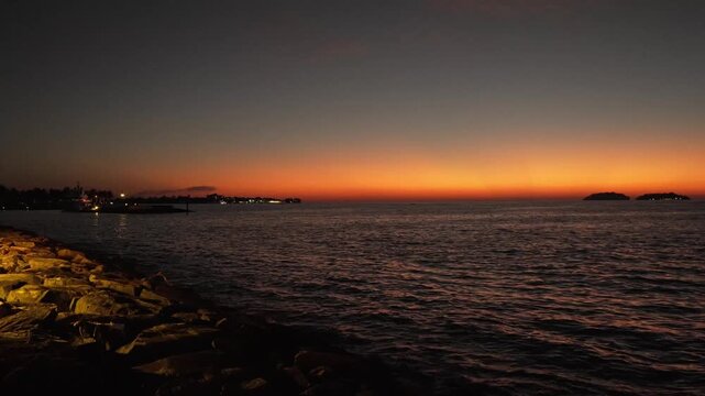Beautiful stuning sunset,with nice city background,with boat and blue sea
