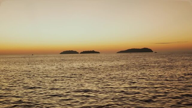 Beautiful stuning sunset,with nice city background,with boat and blue sea